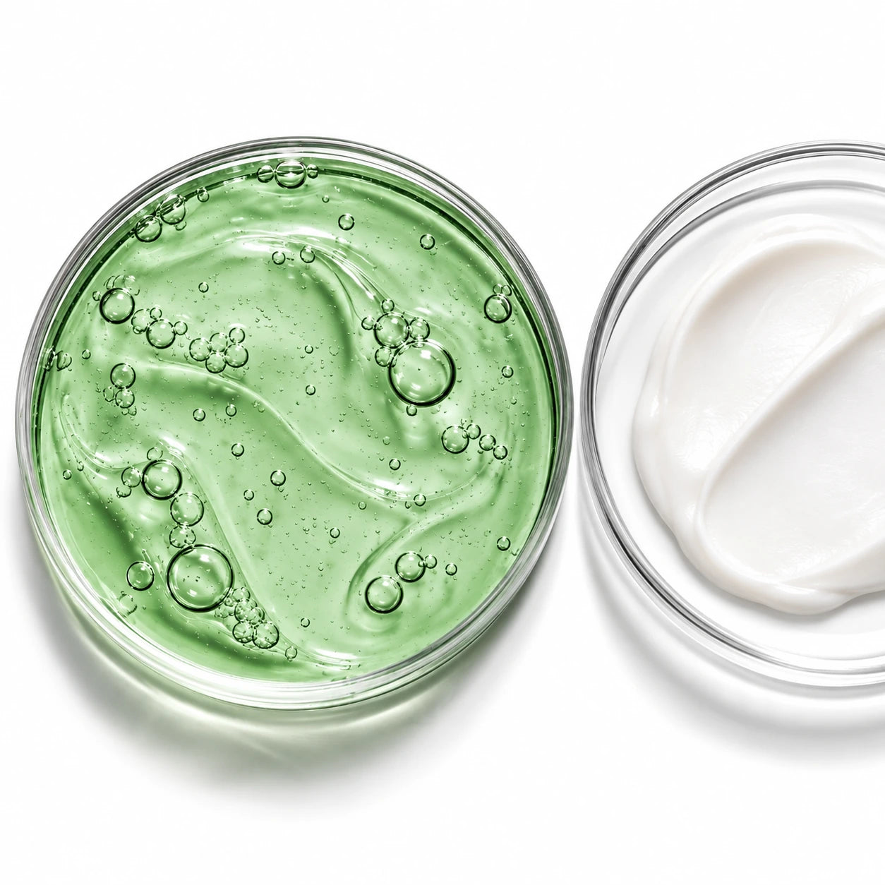 Bio-Aloe-Gel und weiße Creme in gläsernen Petrischalen.